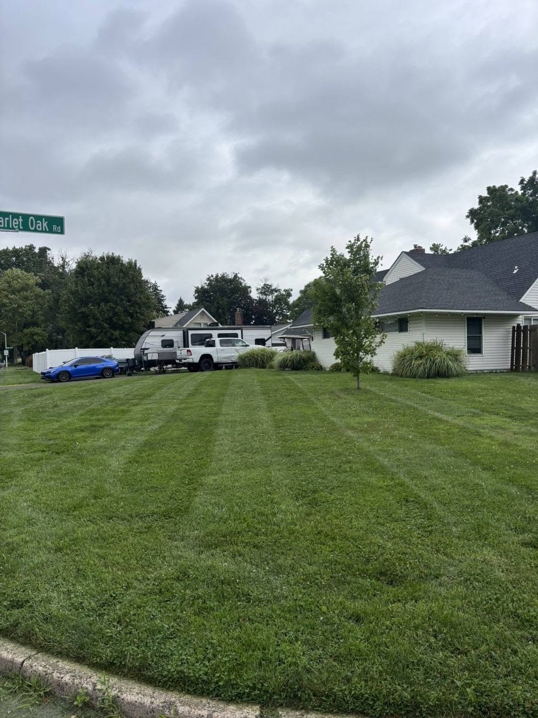 Corner property mowed in even stripes out to the curb